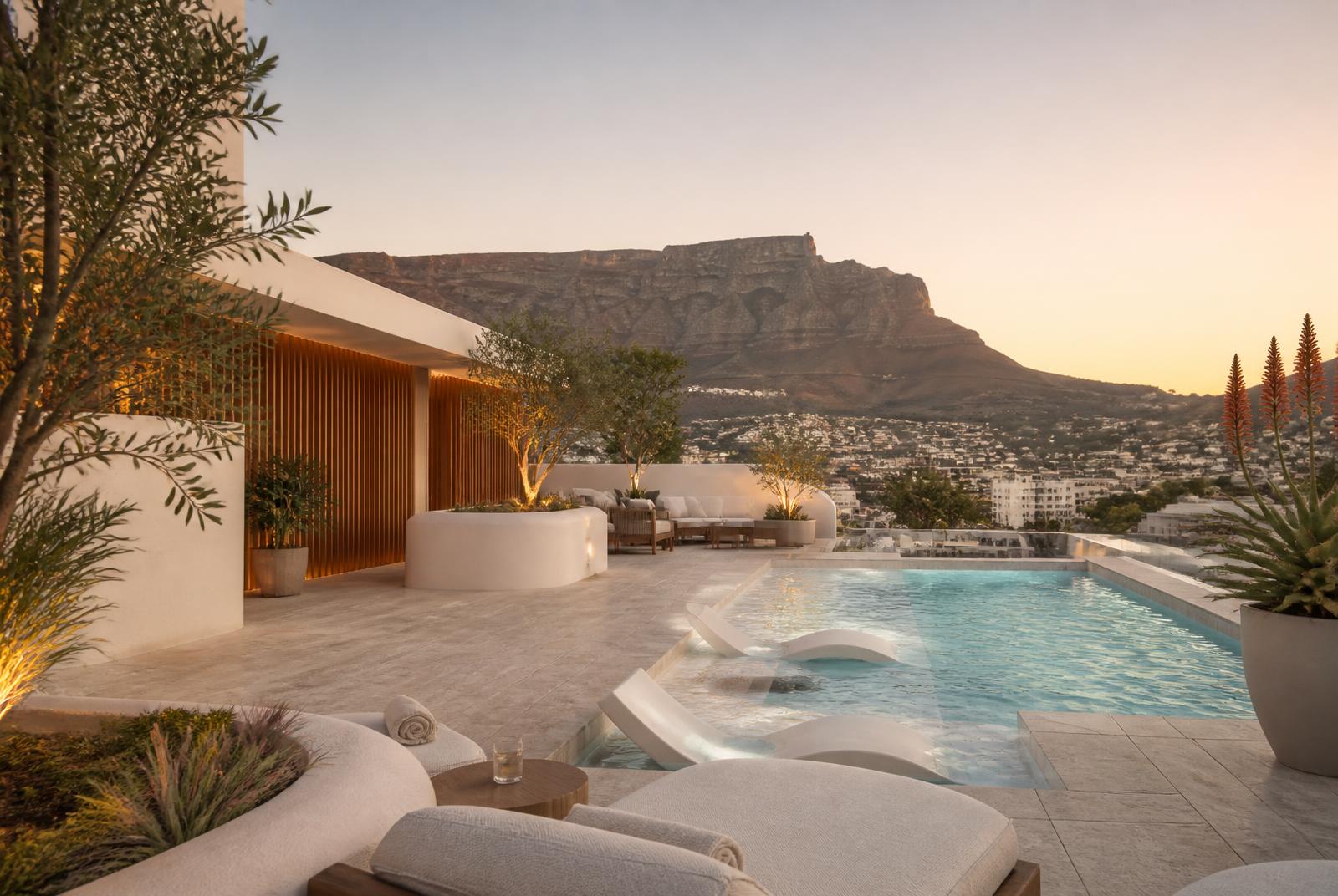 The Lounge Pool at The Selah — A wide leisure pool with a shallow shelf to sit in, travertine deck, oak-screened shade and the mountain in front of you. Drinks come to the lounger.